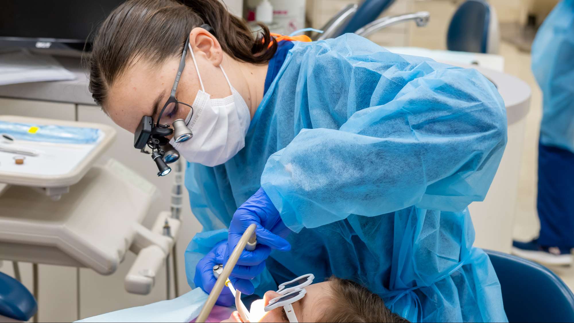 A dental student provides care in the school's pediatric clinic.