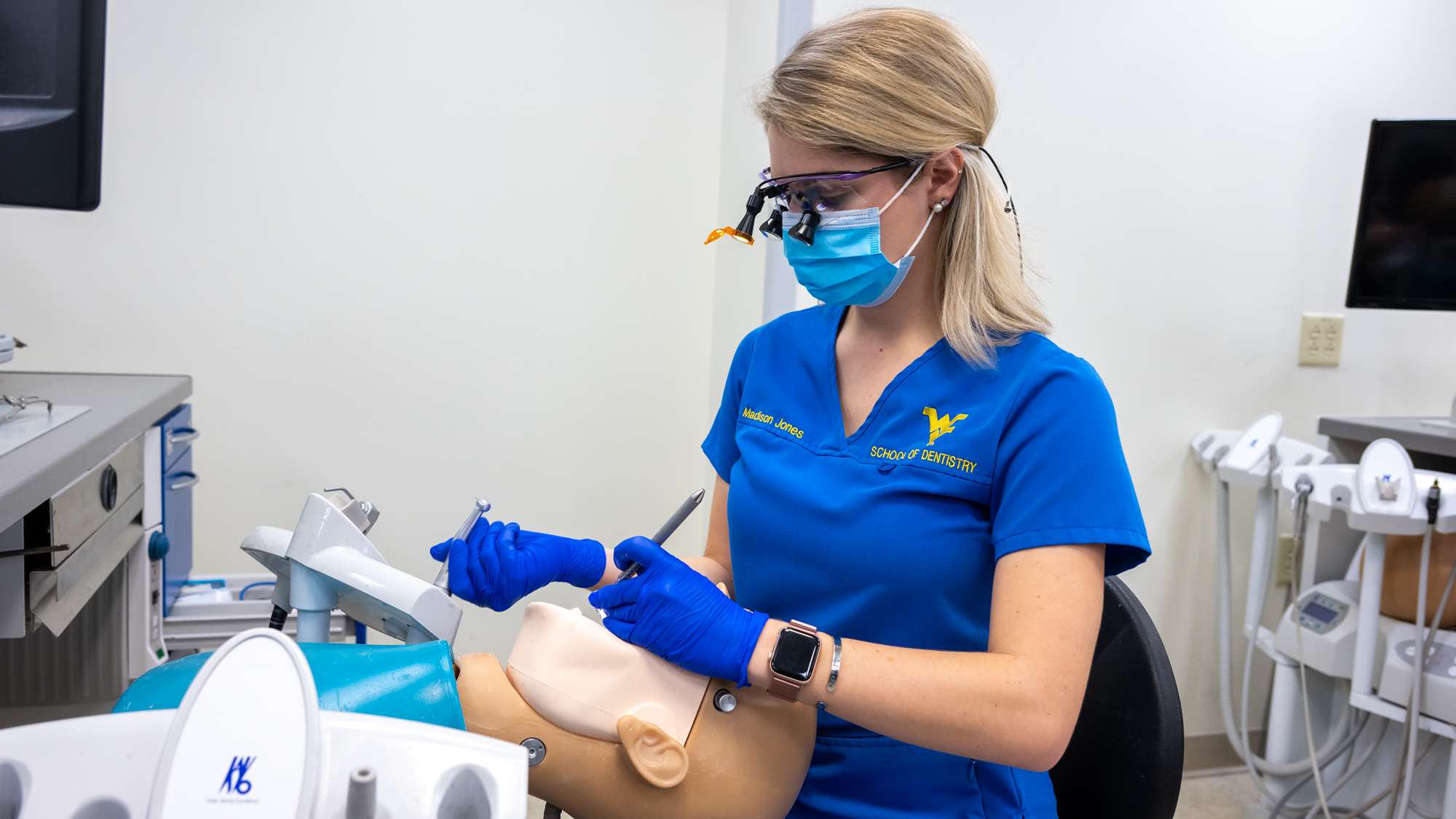 A dental student works in the simulation lab. 